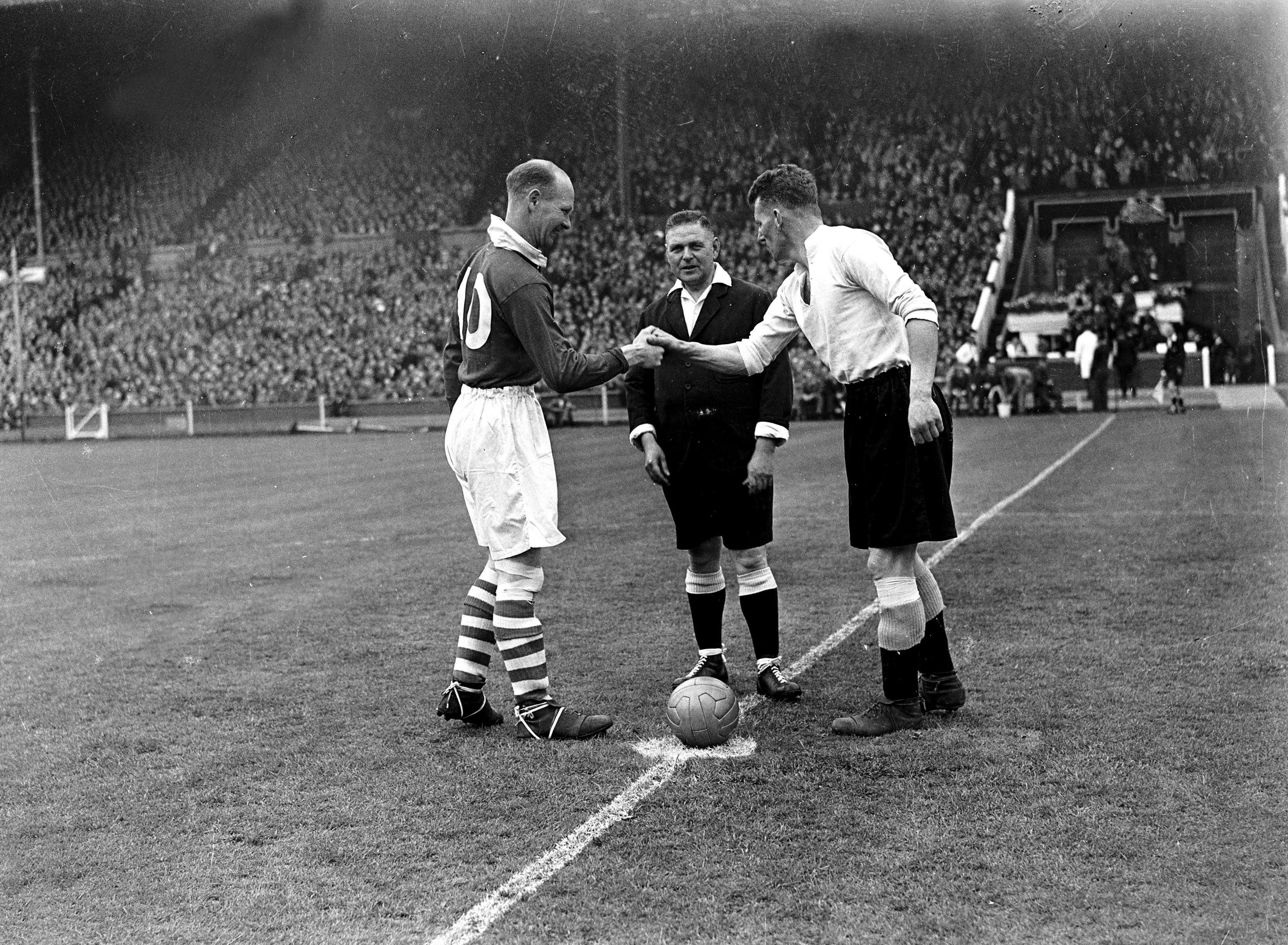 Charlton captain Don Welsh shakes hands with Derby County captain Jack Nicholas ahead of the 1946 FA Cup final