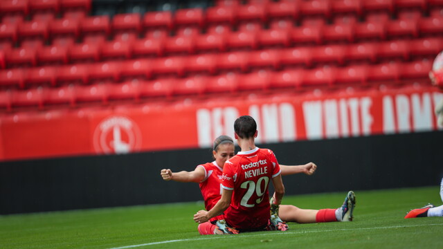Ash Neville knee slides after scoring her 2nd goal of the game