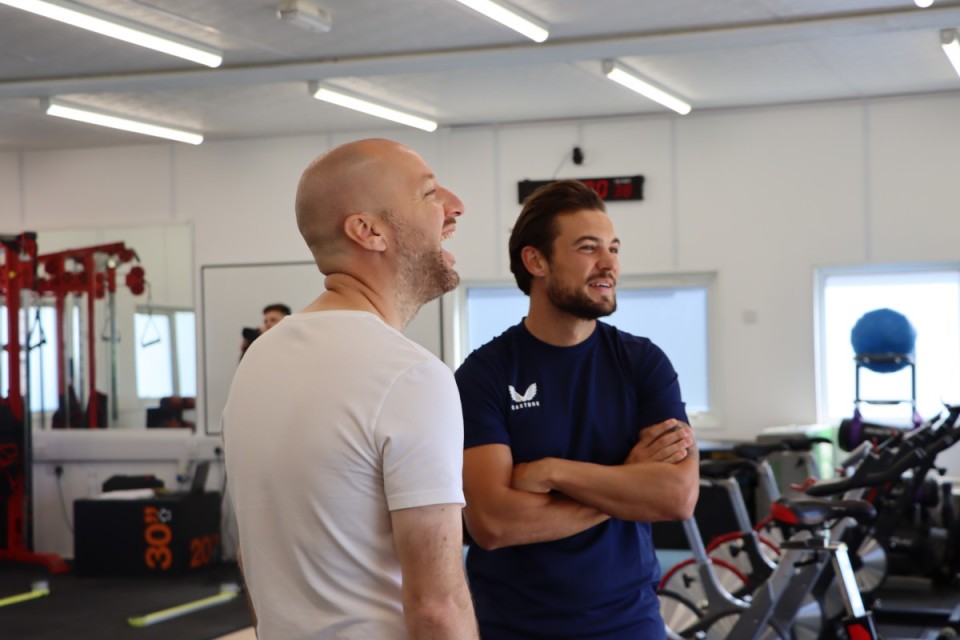 Ben Garner laughs with Jake Forster-Caskey in the gym
