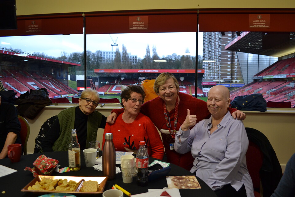 Extra Time members posing for a photo at the table