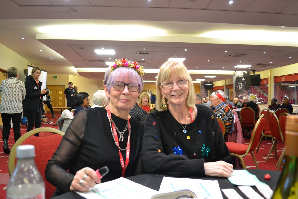 Extra Time members posing for a photo at the table