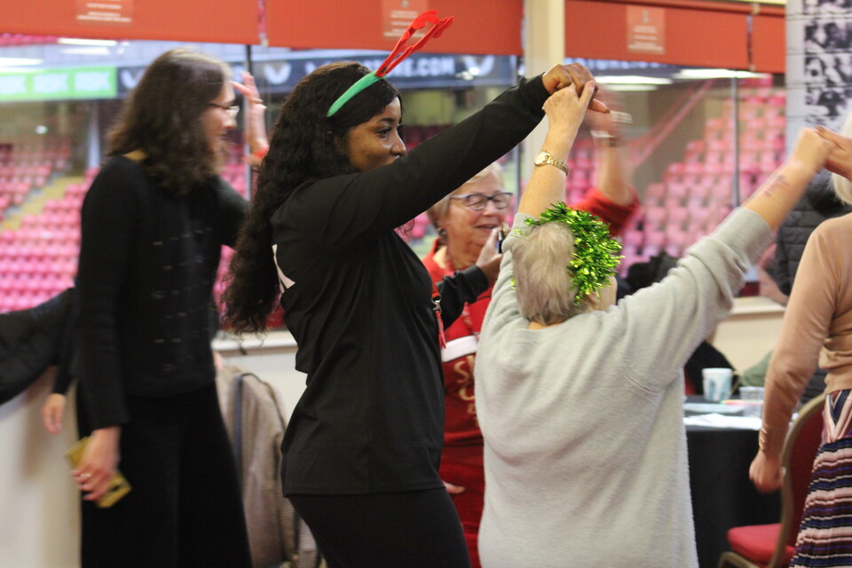 Extra Time members and staff dancing