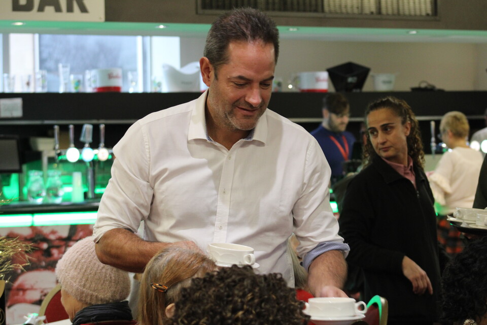 Charlie Methven serving Christmas dinner