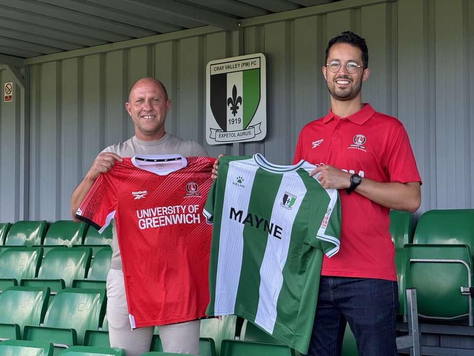 Lawrence and Robinson holding shirts