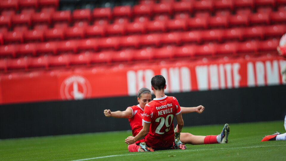 Ash Neville knee slides after scoring her 2nd goal of the game
