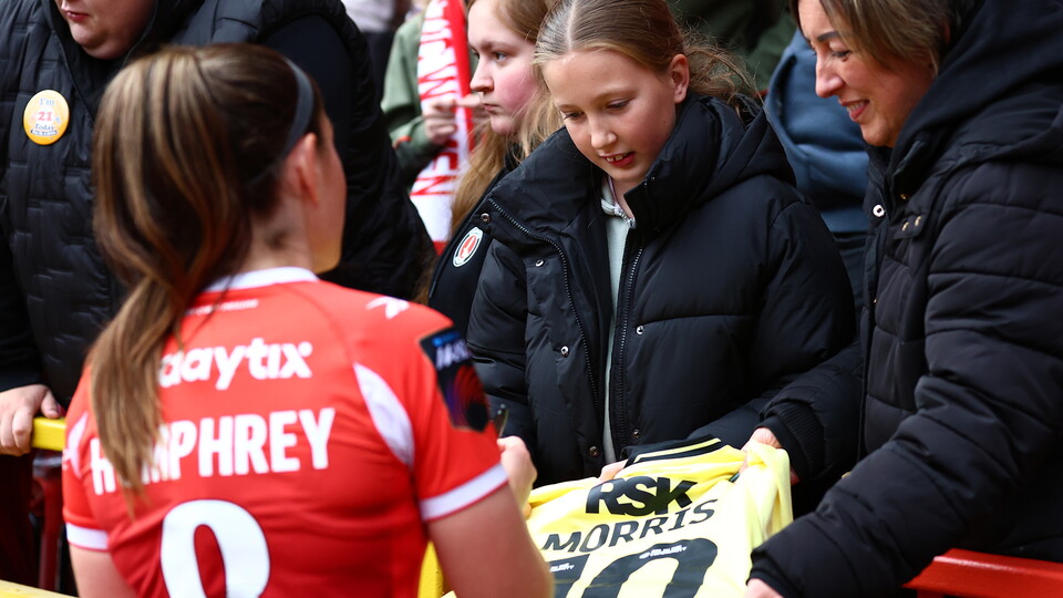 Carla Humphrey signing a fan jersey
